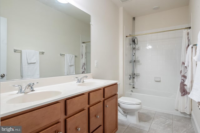 bathroom featuring a sink, shower / bath combo, toilet, and double vanity
