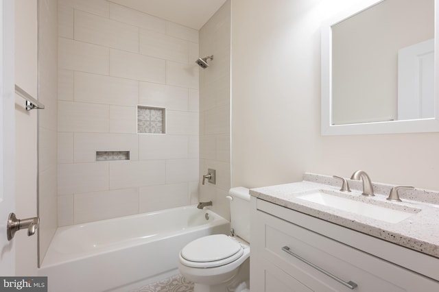 bathroom with vanity, shower / tub combination, and toilet