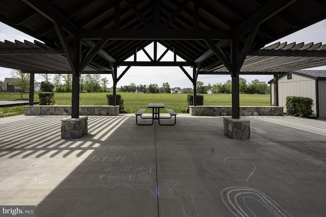 view of home's community featuring a pergola, a gazebo, a patio area, a lawn, and an outdoor structure