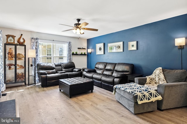 living area with wood finished floors and ceiling fan