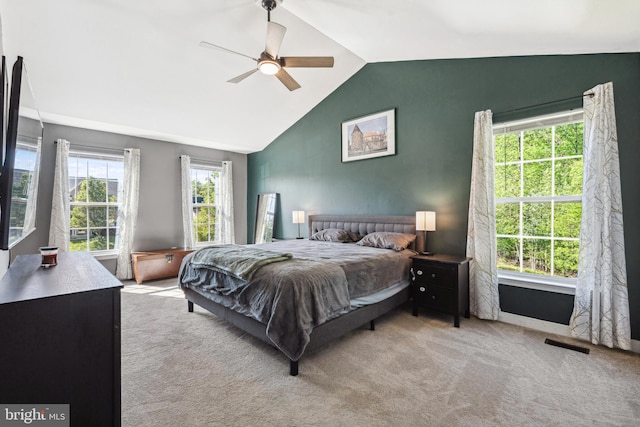 carpeted bedroom featuring visible vents, ceiling fan, and vaulted ceiling