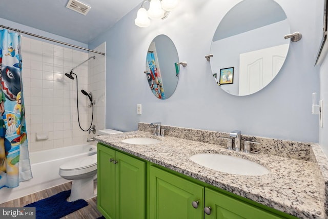 full bath with toilet, a sink, wood finished floors, and visible vents