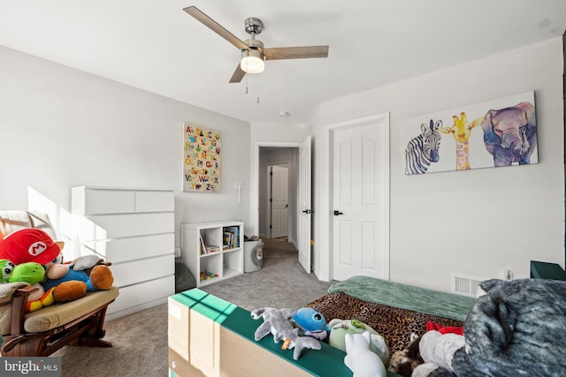 carpeted bedroom featuring visible vents and ceiling fan
