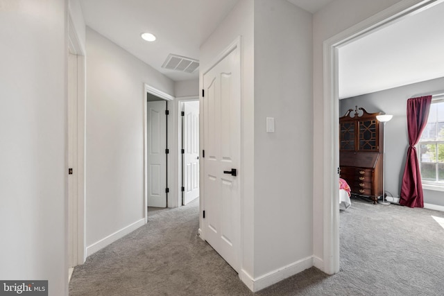 hallway with visible vents, baseboards, recessed lighting, and carpet floors