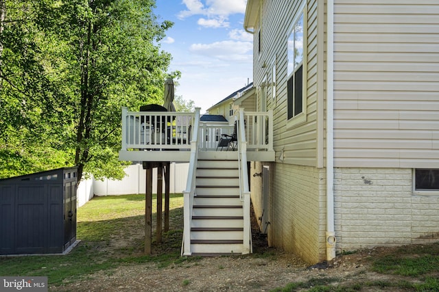 view of property exterior featuring a wooden deck and stairway