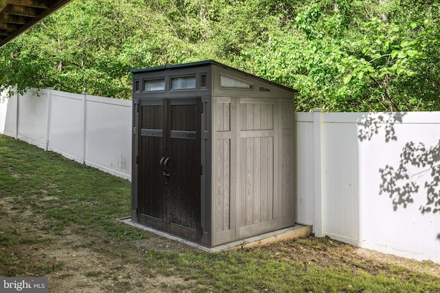 view of shed with fence