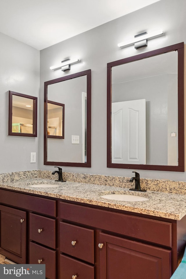 full bath featuring double vanity and a sink