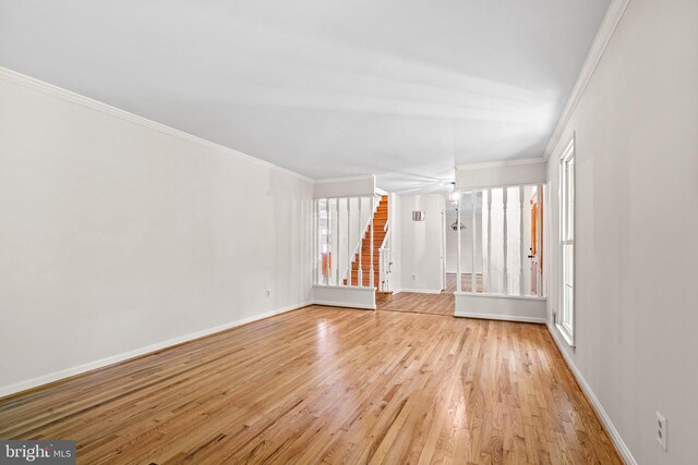 5420 Well Spring Rd, La Plata, MD 20646 - unfurnished living room with stairs, baseboards, light wood finished floors, and crown molding