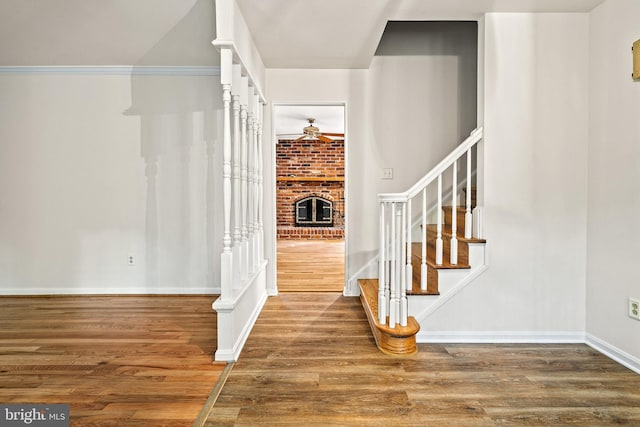 5420 Well Spring Rd, La Plata, MD 20646 - staircase with a ceiling fan, wood finished floors, a brick fireplace, and baseboards