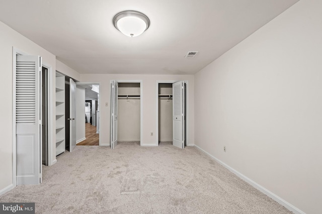 5420 Well Spring Rd, La Plata, MD 20646 - unfurnished bedroom with multiple closets, carpet floors, and baseboards