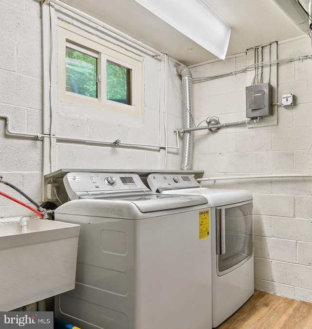 5420 Well Spring Rd, La Plata, MD 20646 - washroom featuring independent washer and dryer, wood finished floors, and a sink
