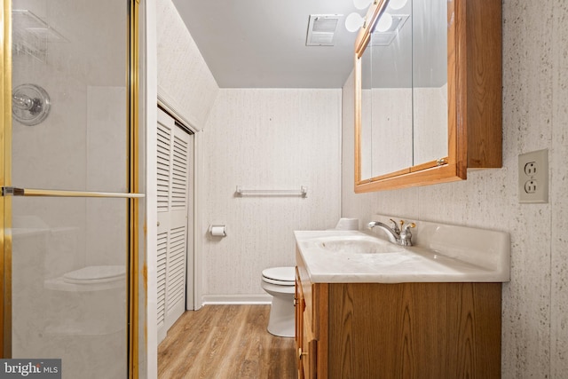 5420 Well Spring Rd, La Plata, MD 20646 - bathroom with wood finished floors, toilet, a shower stall, vanity, and wallpapered walls