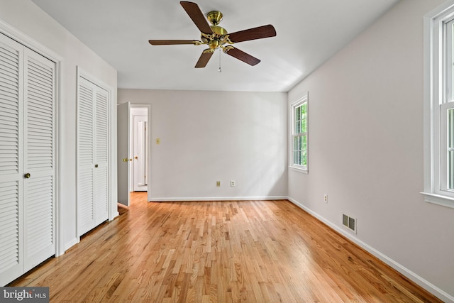 5420 Well Spring Rd, La Plata, MD 20646 - unfurnished bedroom with baseboards, light wood-style floors, ceiling fan, and multiple closets