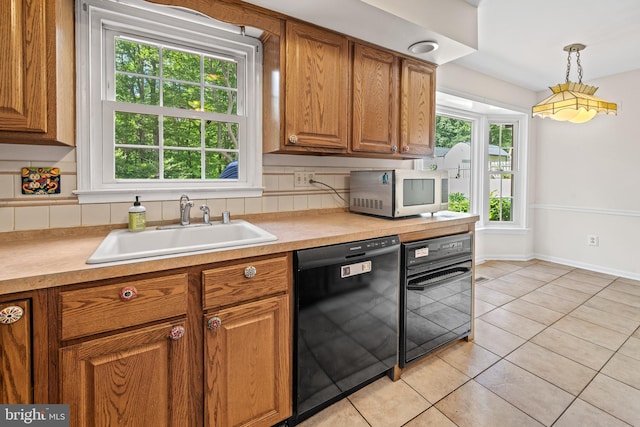 5420 Well Spring Rd, La Plata, MD 20646 - kitchen with dishwasher, a sink, brown cabinetry, light countertops, and light tile patterned flooring