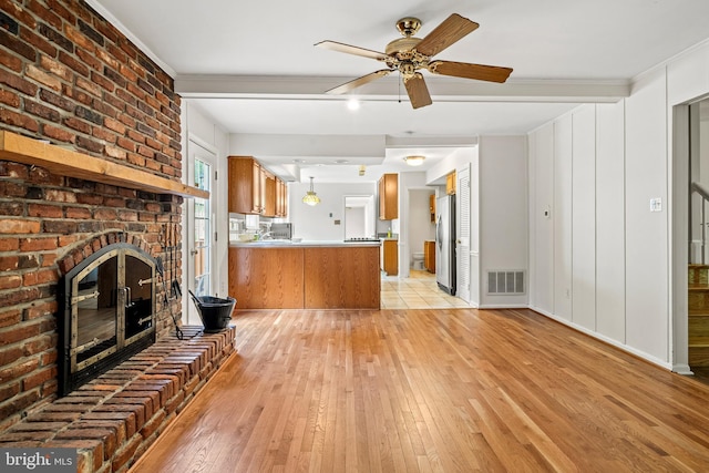 5420 Well Spring Rd, La Plata, MD 20646 - unfurnished living room featuring light wood-type flooring, a fireplace, crown molding, and ceiling fan