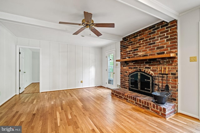 5420 Well Spring Rd, La Plata, MD 20646 - unfurnished living room featuring hardwood / wood-style flooring, ornamental molding, beam ceiling, a ceiling fan, and a brick fireplace