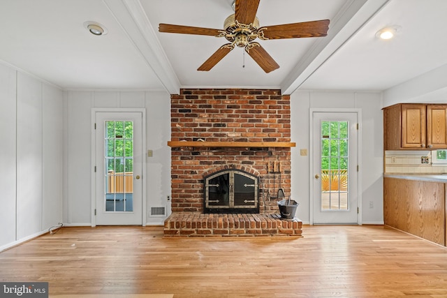 5420 Well Spring Rd, La Plata, MD 20646 - unfurnished living room with beam ceiling, plenty of natural light, hardwood / wood-style flooring, a brick fireplace, and a ceiling fan
