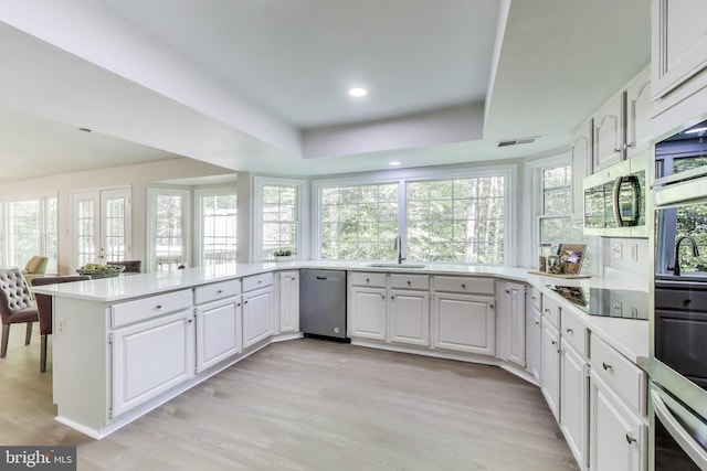12148 Darnley Rd, Woodbridge, VA 22192 - kitchen with a sink, appliances with stainless steel finishes, light countertops, light wood finished floors, and recessed lighting