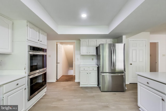 12148 Darnley Rd, Woodbridge, VA 22192 - kitchen with appliances with stainless steel finishes, white cabinets, light countertops, and a raised ceiling