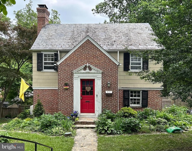 831 Glen Allen Dr, Baltimore, MD 21229 - view of front of home with a high end roof, brick siding, and a chimney