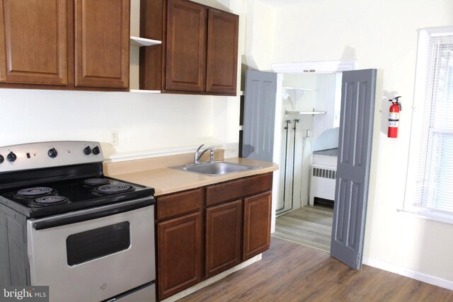 466 N Evans St, Pottstown, PA 19464 - kitchen with wood finished floors, electric range, light countertops, radiator, and a sink