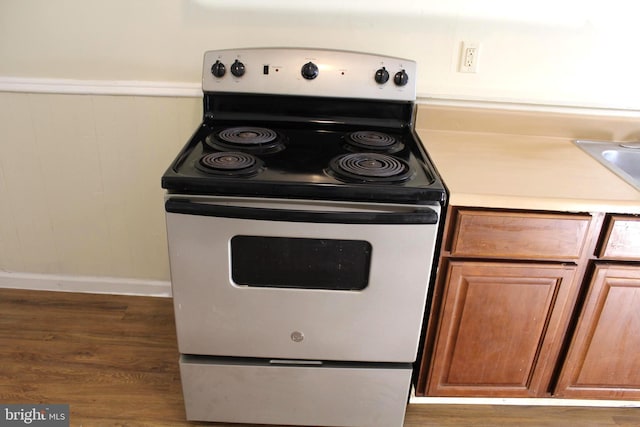 466 N Evans St, Pottstown, PA 19464 - kitchen with wood finished floors, brown cabinetry, light countertops, electric range oven, and baseboards