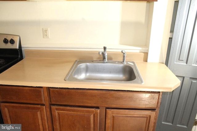 466 N Evans St, Pottstown, PA 19464 - kitchen with brown cabinets, electric range oven, light countertops, and a sink