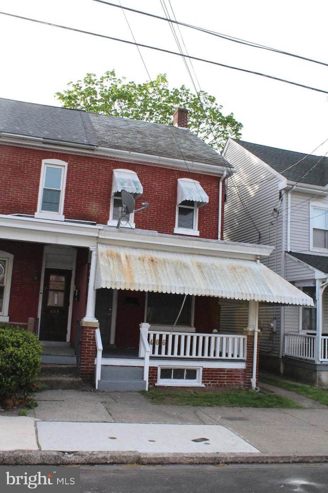 466 N Evans St, Pottstown, PA 19464 - view of property featuring a chimney, covered porch, and brick siding