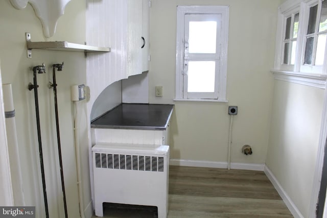 466 N Evans St, Pottstown, PA 19464 - washroom featuring wood finished floors, a healthy amount of sunlight, laundry area, and radiator