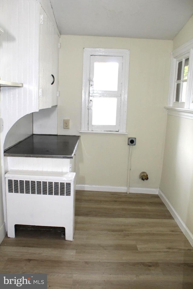 466 N Evans St, Pottstown, PA 19464 - laundry room with baseboards, radiator heating unit, and wood finished floors