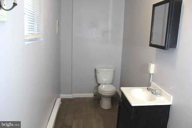 466 N Evans St, Pottstown, PA 19464 - bathroom featuring baseboards, wood finished floors, toilet, and vanity