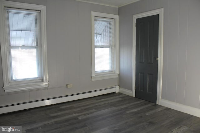 466 N Evans St, Pottstown, PA 19464 - unfurnished room with dark wood finished floors, a decorative wall, a baseboard heating unit, ornamental molding, and baseboards