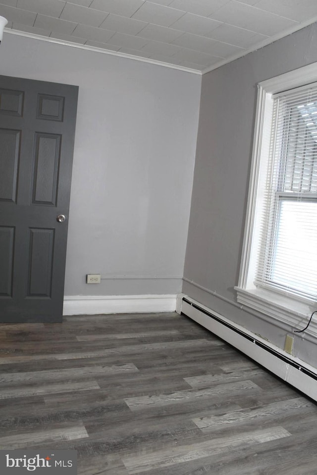 466 N Evans St, Pottstown, PA 19464 - empty room with wood finished floors, crown molding, a baseboard heating unit, and baseboards