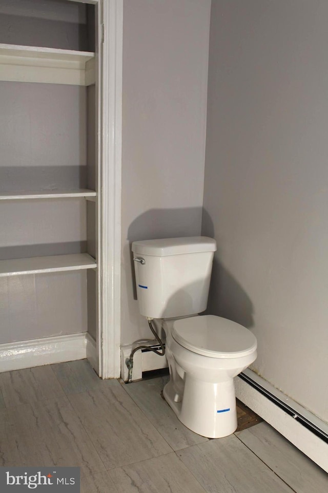 466 N Evans St, Pottstown, PA 19464 - bathroom featuring baseboard heating, baseboards, wood finished floors, and toilet