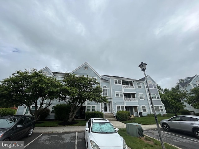 view of building exterior with uncovered parking