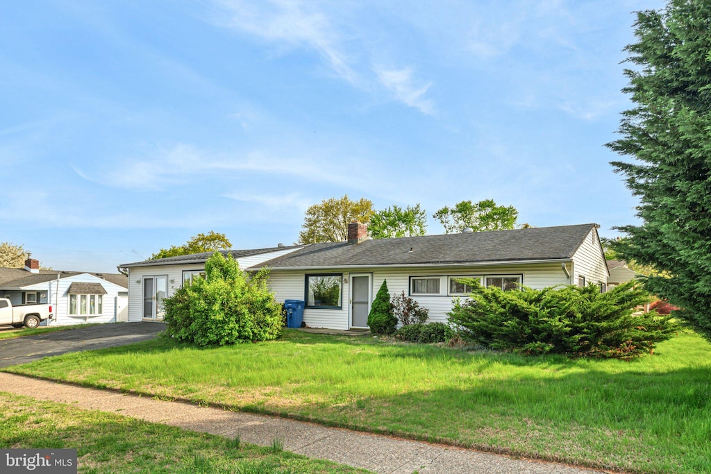 97 Black Pine Ln, Levittown, PA 19054 - ranch-style home with a chimney, aphalt driveway, and a front yard