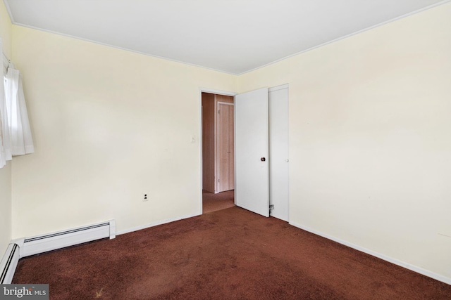 empty room with a baseboard radiator, carpet floors, and baseboards