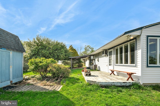 view of yard with a wooden deck, an outbuilding, and a storage shed