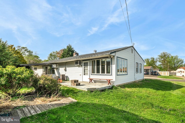 rear view of property featuring a yard and a chimney