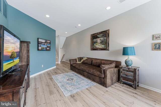 living room with light wood finished floors, stairway, recessed lighting, and baseboards