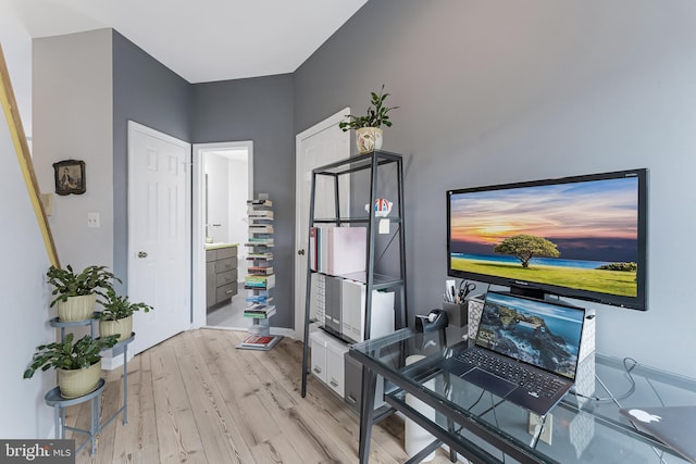 office space featuring light wood-type flooring and baseboards