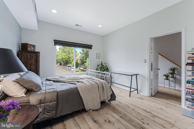 bedroom featuring wood finished floors, recessed lighting, and baseboards