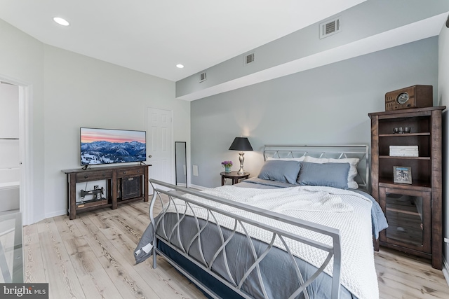 bedroom with light wood-style flooring and recessed lighting