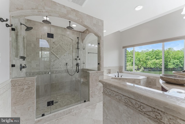 bathroom featuring a bath, a shower stall, and recessed lighting