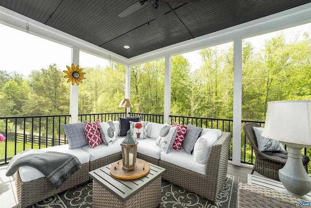 sunroom featuring a ceiling fan and an outdoor hangout area