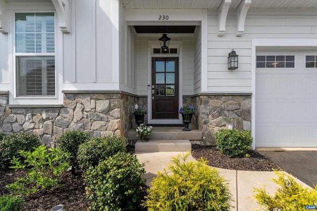 entrance to property with a garage and stone siding