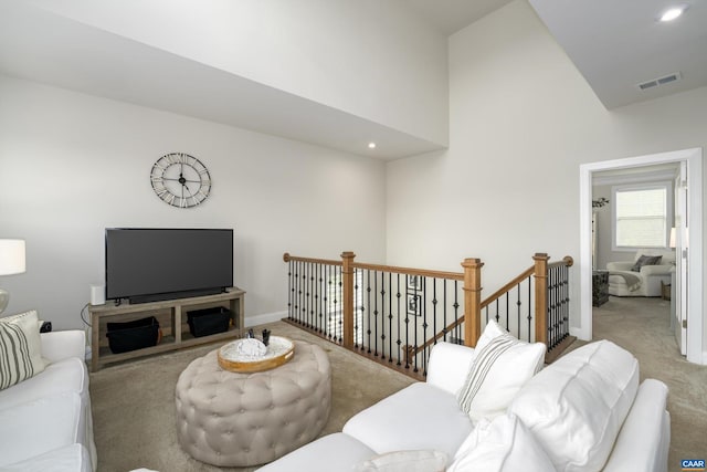living room featuring carpet floors, recessed lighting, high vaulted ceiling, and visible vents
