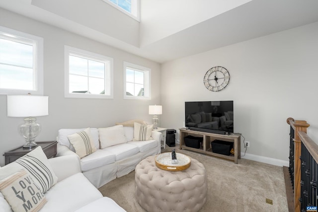 carpeted living room featuring baseboards