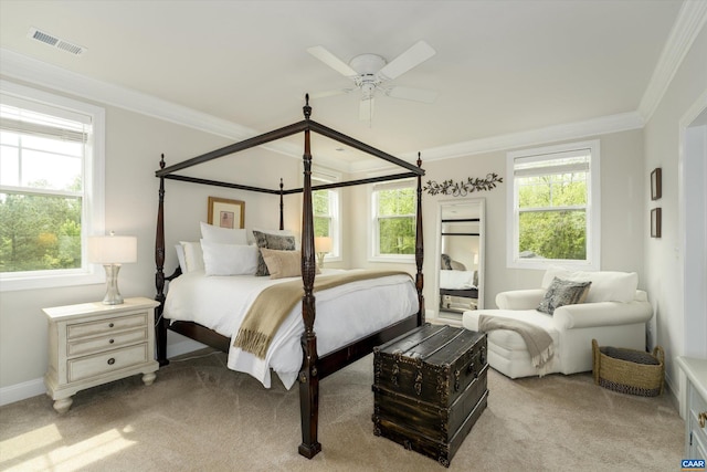 bedroom with visible vents, crown molding, and light carpet