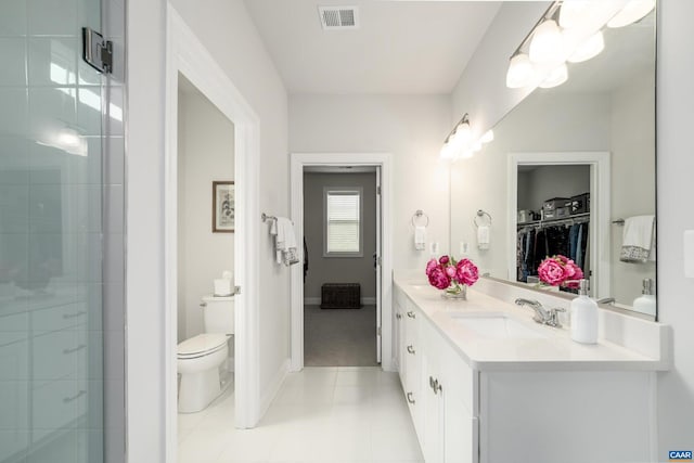 bathroom with vanity, toilet, tile patterned floors, a shower stall, and visible vents